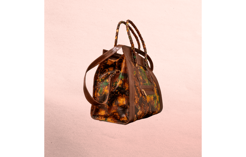 Leather body and trim. Short handles for carrying  and long shoulder straps. Inside and outside pockets! Top zipper. Measures 20.5” x 12.