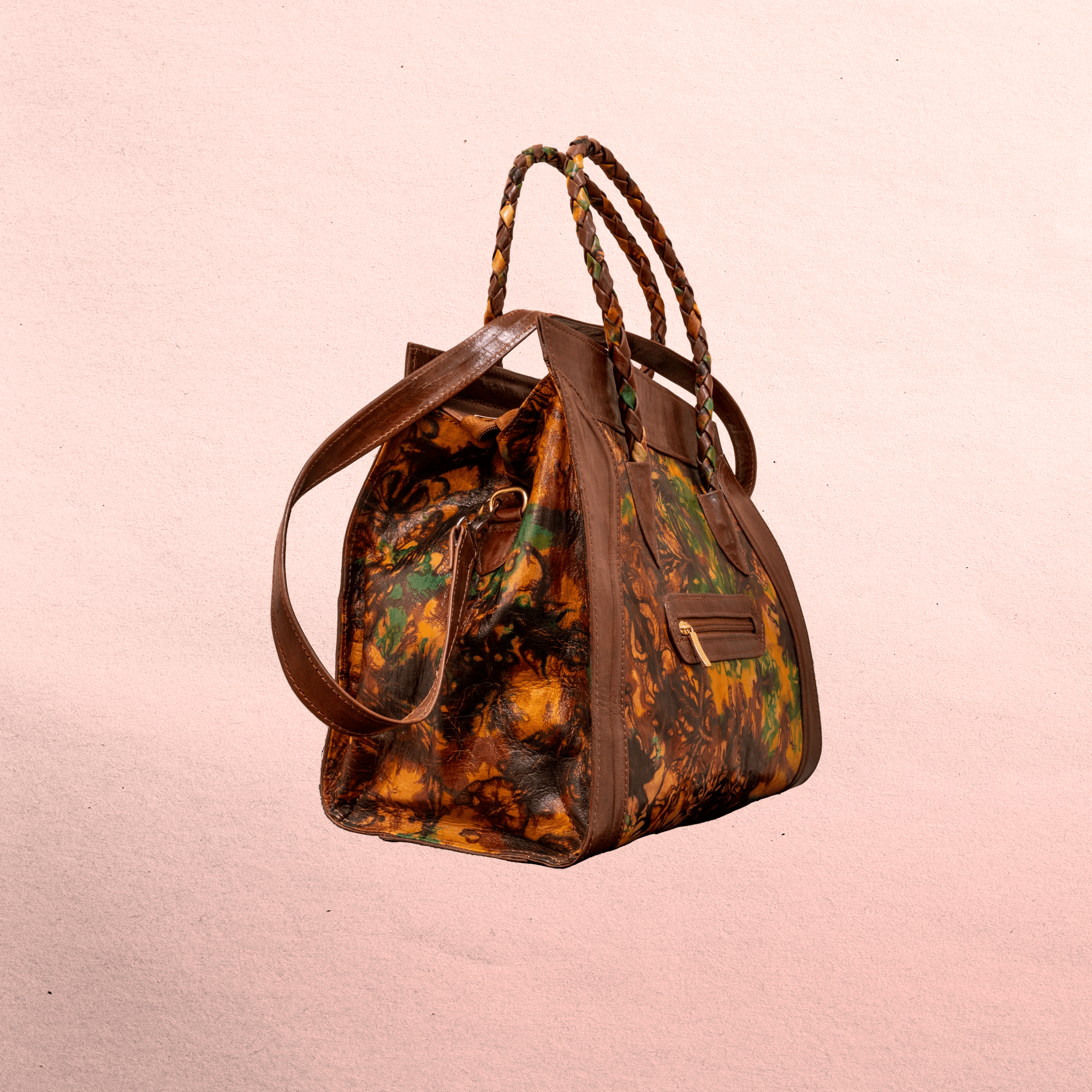 Leather body and trim. Short handles for carrying  and long shoulder straps. Inside and outside pockets! Top zipper. Measures 20.5” x 12.