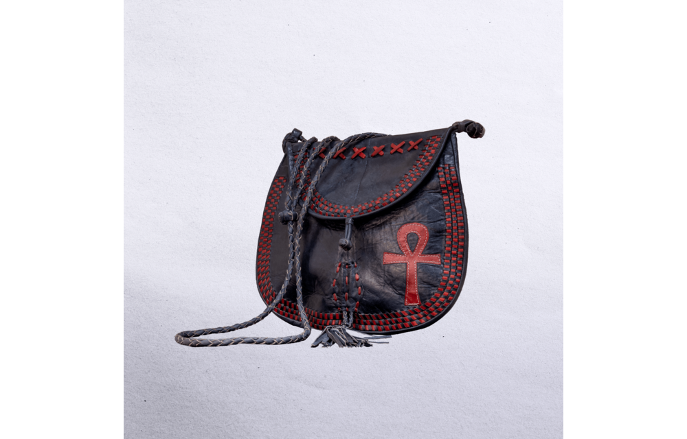 Beautiful cross-body leather bag. Has braided leather straps with Ankh adornment. Inside and outside pockets.