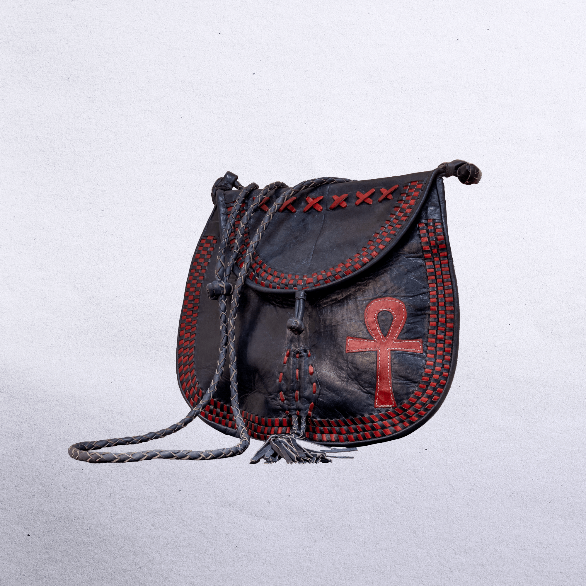 Beautiful cross-body leather bag. Has braided leather straps with Ankh adornment. Inside and outside pockets.