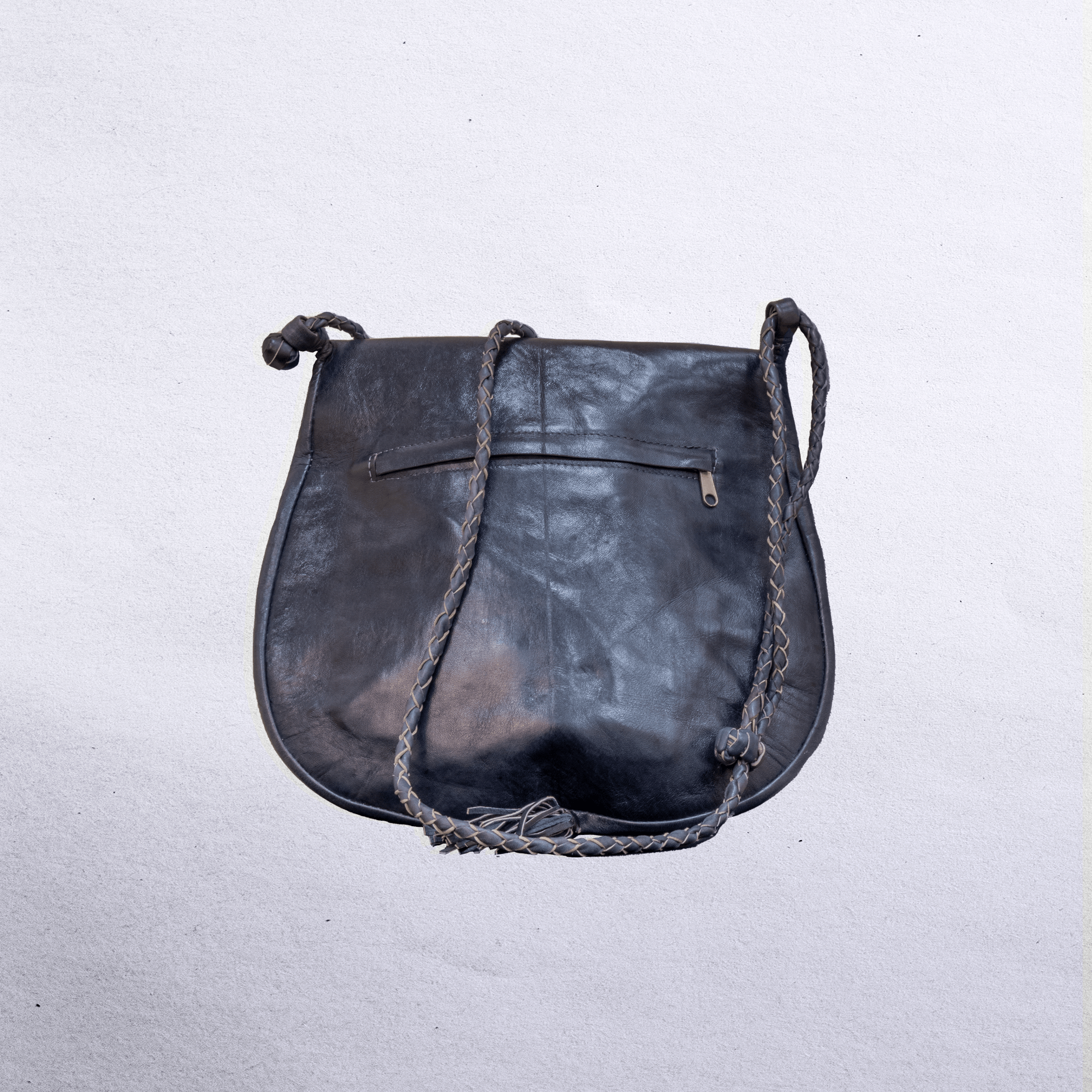 Beautiful cross-body leather bag. Has braided leather straps with Ankh adornment. Inside and outside pockets.