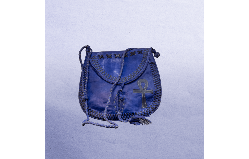 Beautiful cross-body leather bag. Has braided leather straps with Ankh adornment. Inside and outside pockets.