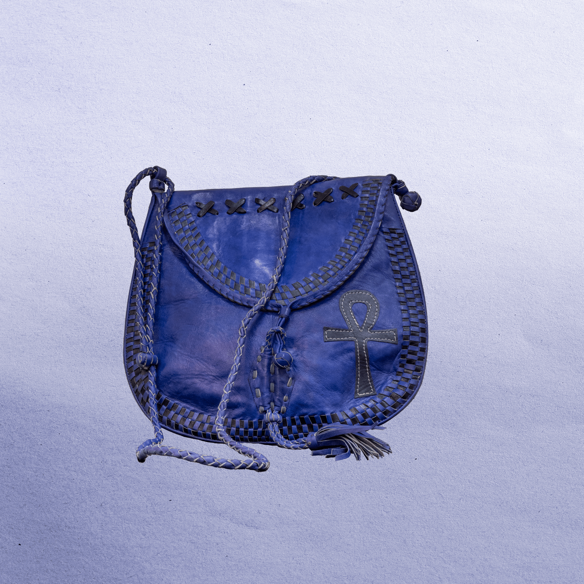 Beautiful cross-body leather bag. Has braided leather straps with Ankh adornment. Inside and outside pockets.