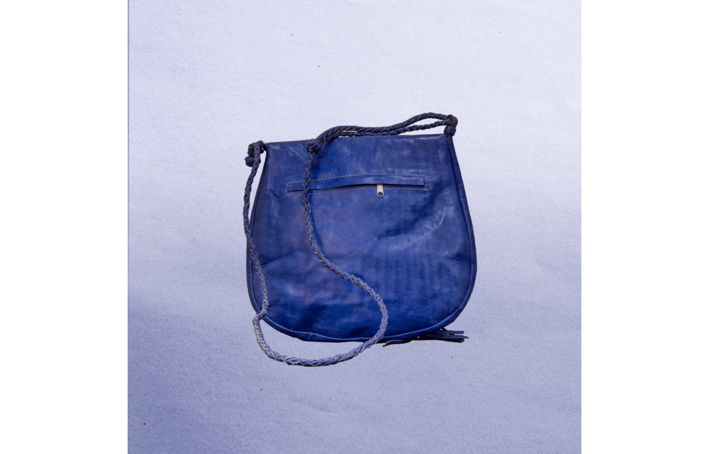 Beautiful cross-body leather bag. Has braided leather straps with Ankh adornment. Inside and outside pockets.