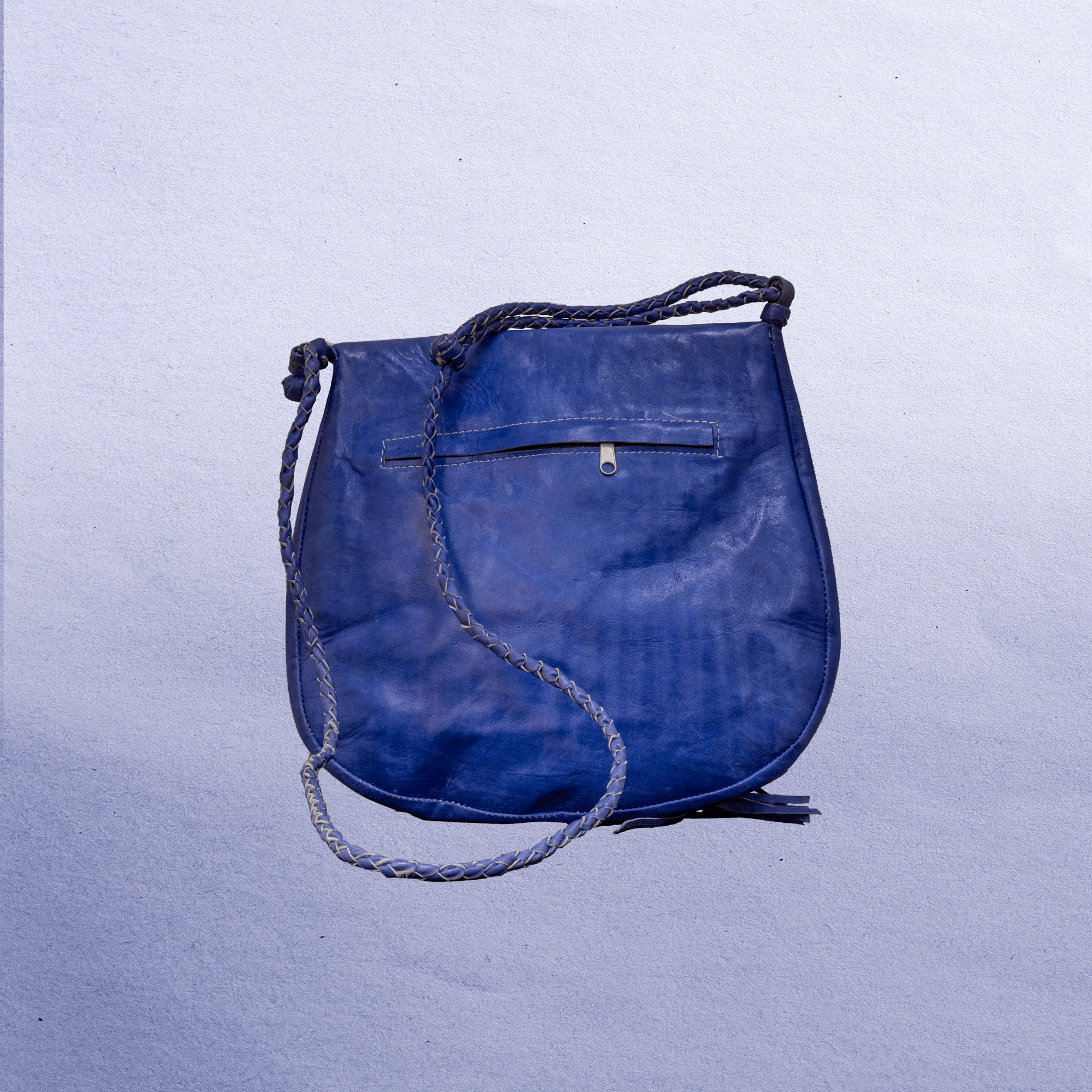 Beautiful cross-body leather bag. Has braided leather straps with Ankh adornment. Inside and outside pockets.