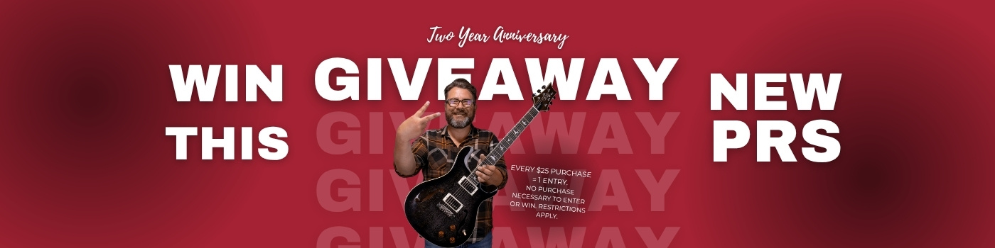 ken holding a prs semi-hollow body electric guitar