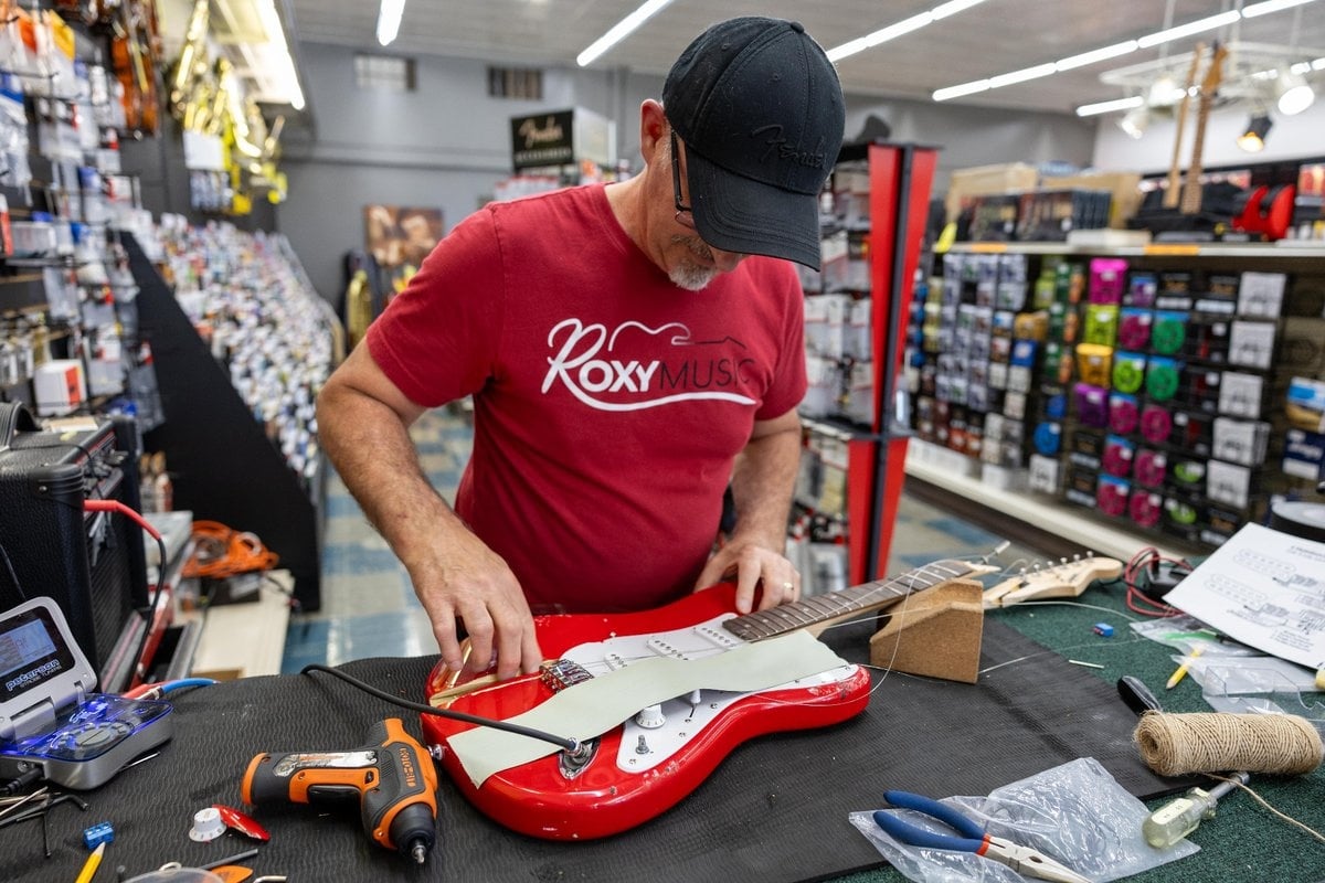 A team member painting the guitar wall during Roxy Music’s interior remodel