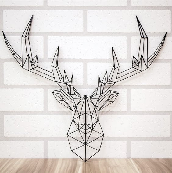 Wall ornament of a deer made of triangular shapes cut by FLUX Beambox Pro.