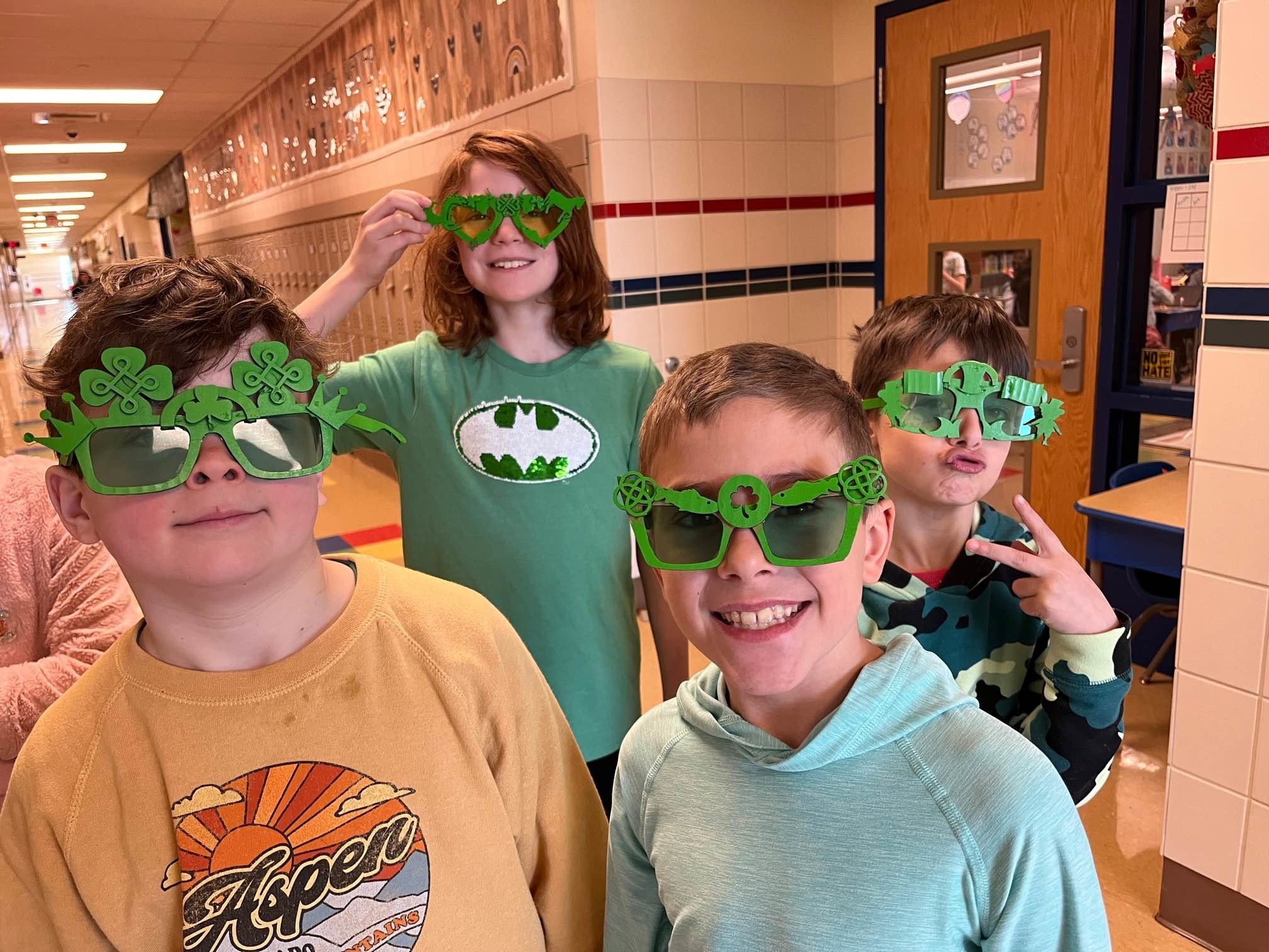 Kids showing of the Saint Patrick’s Day items they made with their laser cutter