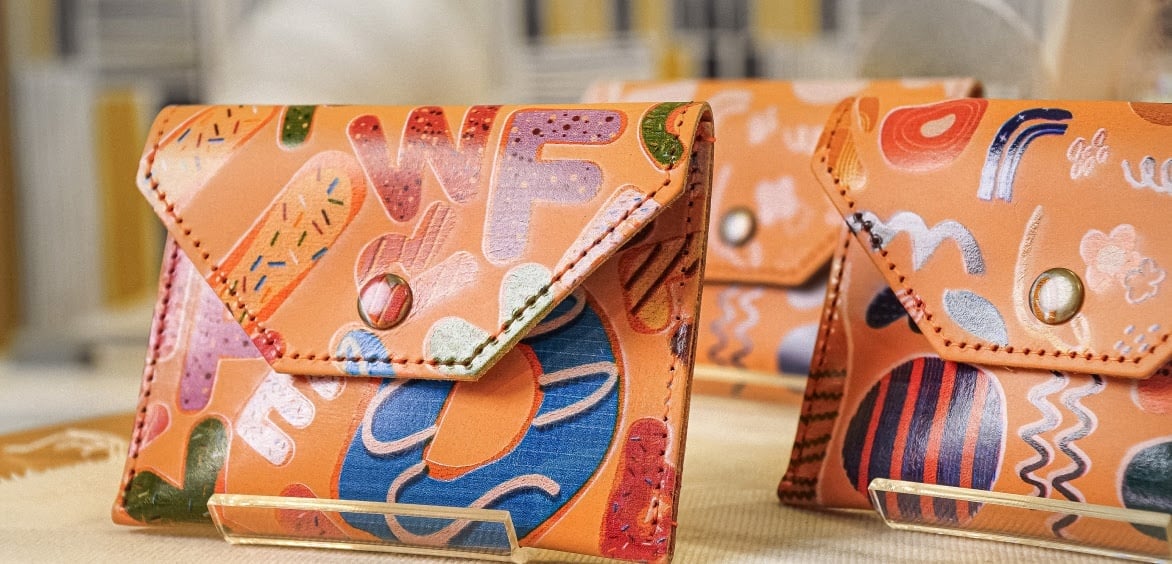 Two leather purses with a color printed design done with a FLUX Ador.