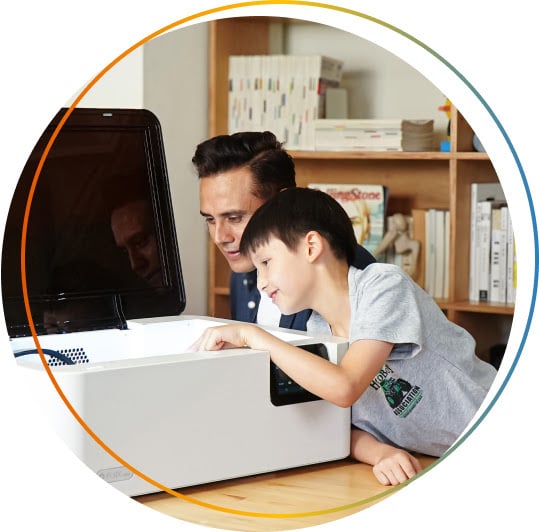 Man and a young boy looking inside a FLUX Ador.