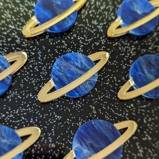 Planet pins made with a FLUX laser cutter