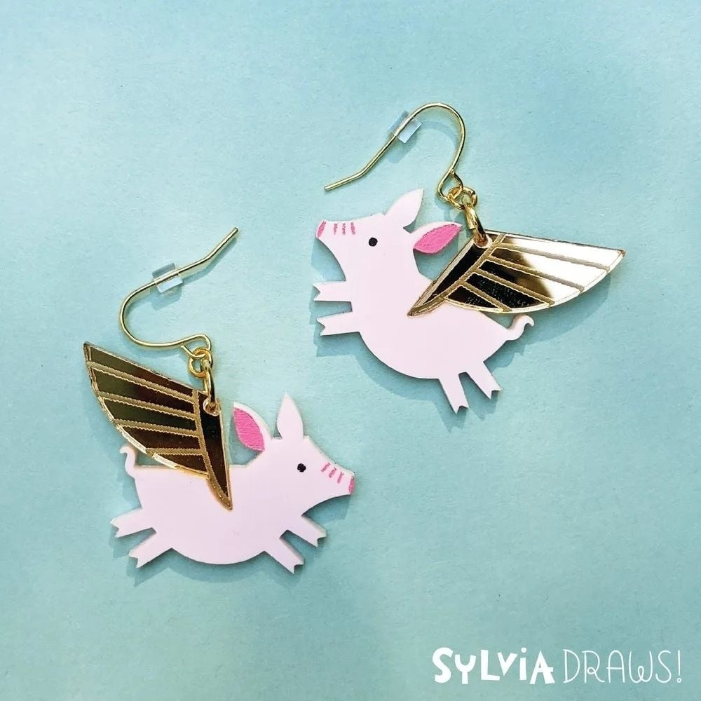 Flying pig earrings made with a FLUX laser cutter