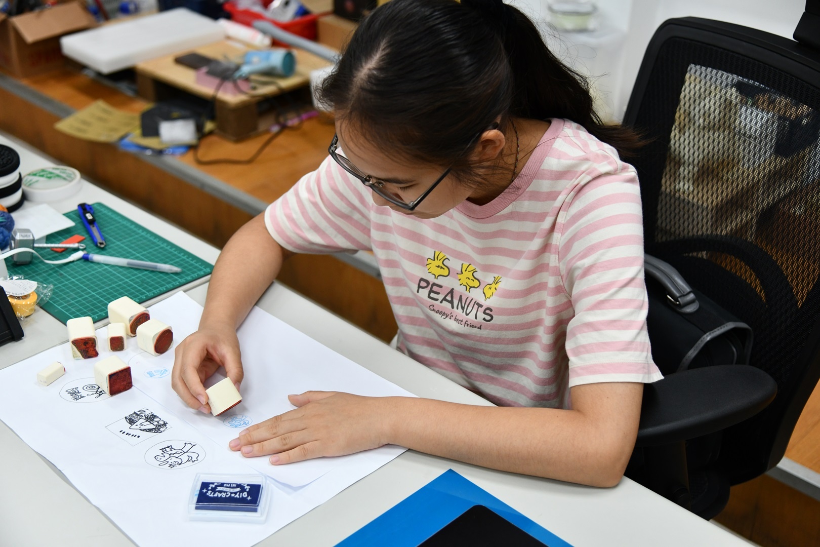 A student using their own custom rubber stamps