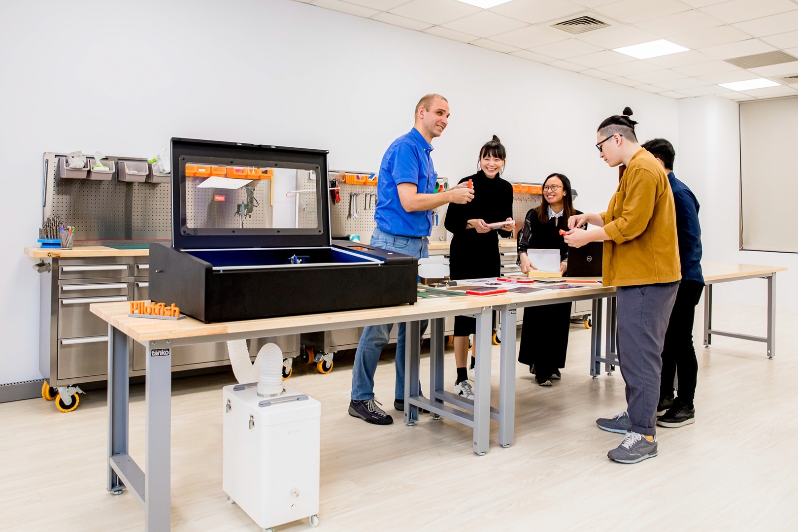 Pilotfish product development team using a FLUX laser cutter