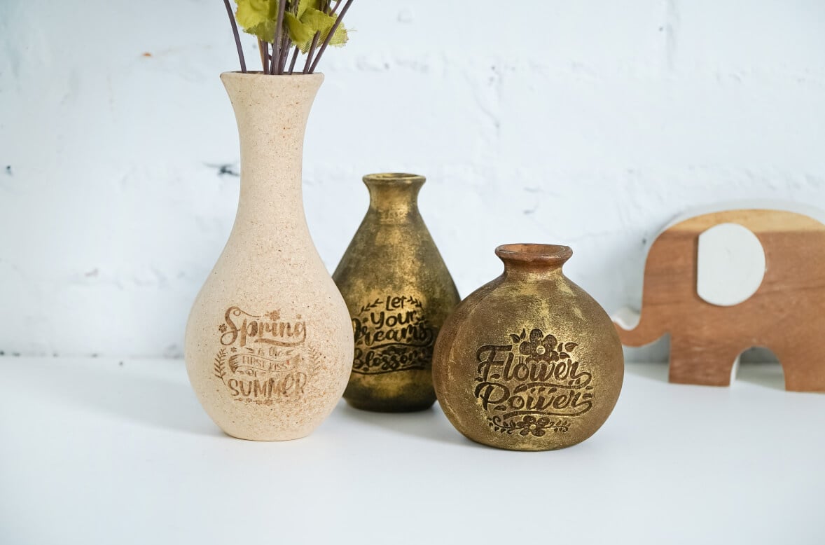 Three ceramic vases with engraved designs by the FLUX Ador rotary module.