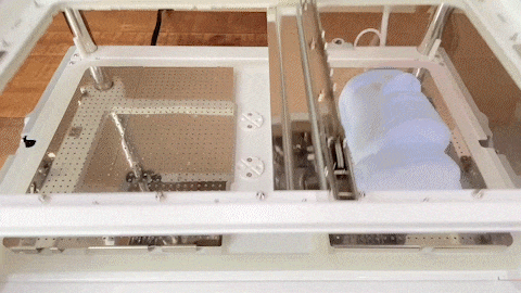 PET sheets being pulled over a mold during vacuum forming