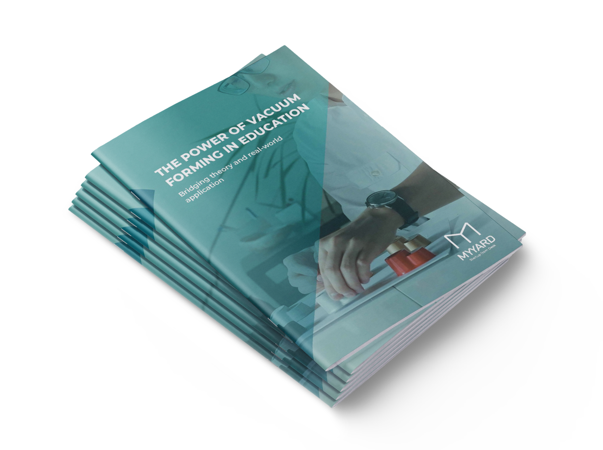 Stack of printed whitepapers with the title 'The power of vacuum forming in education.'