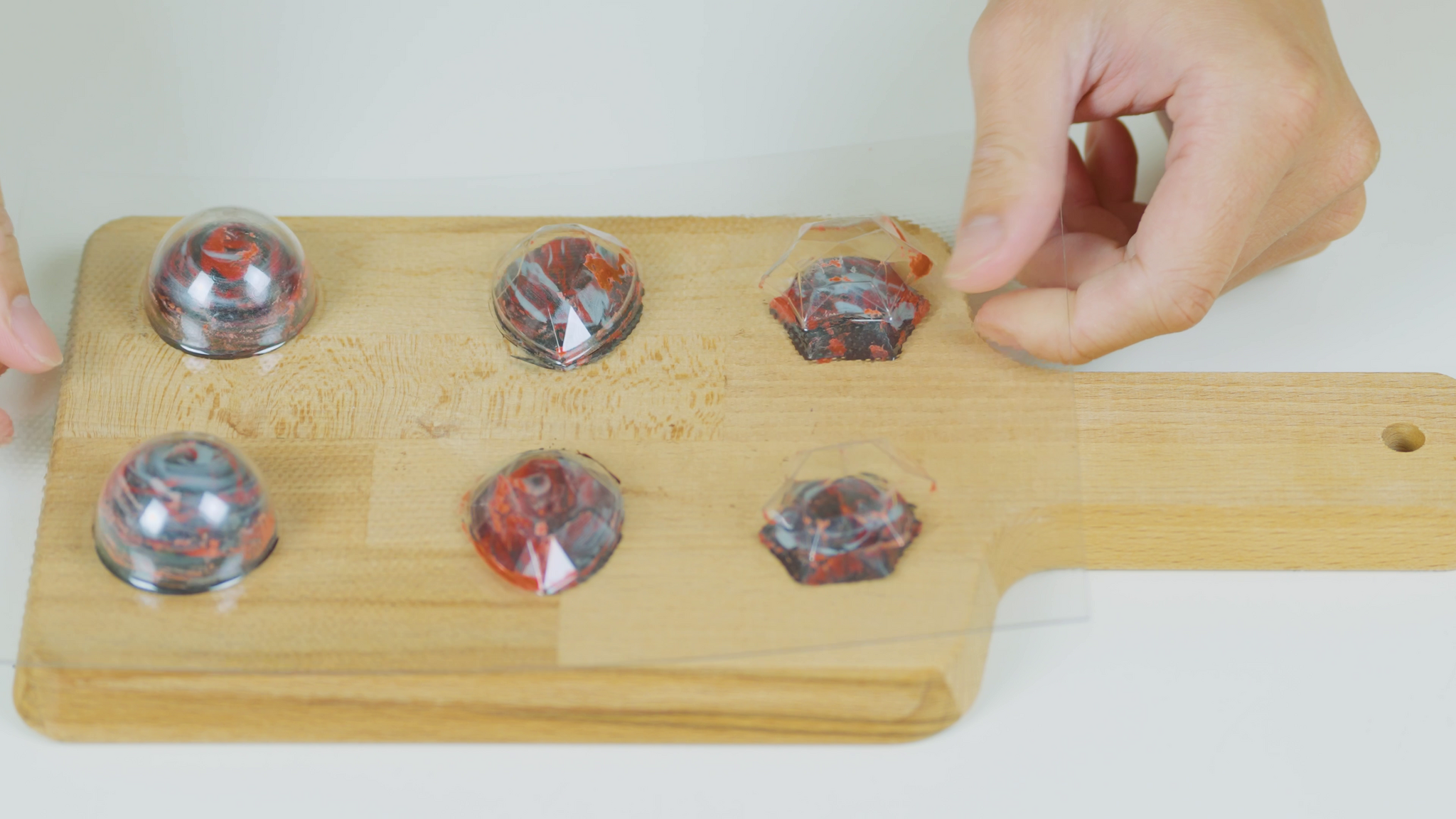 Removing the chocolates from their custom mold