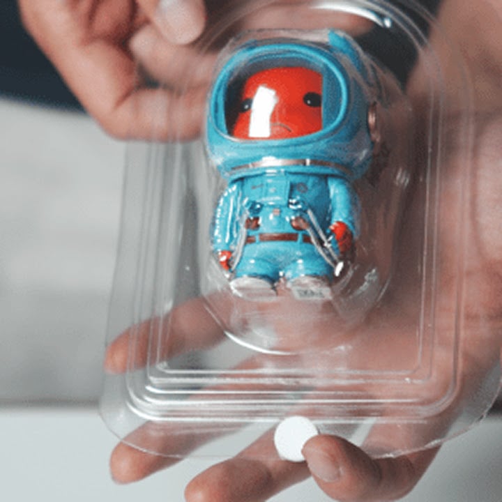 Vacuum formed blister packaging for a toy astronaut figurine.
