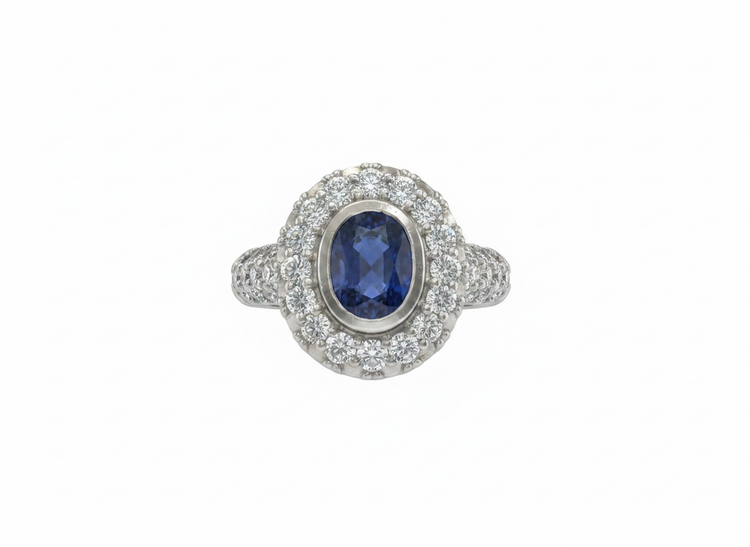 RYAN GEMS INC (Y)18KW 1.50SA 1.40DIA  OVAL BEVEL SET SAPPHIRE CENTER STONE SURROUNDED BY CLUSTERS OF DIAMONDS