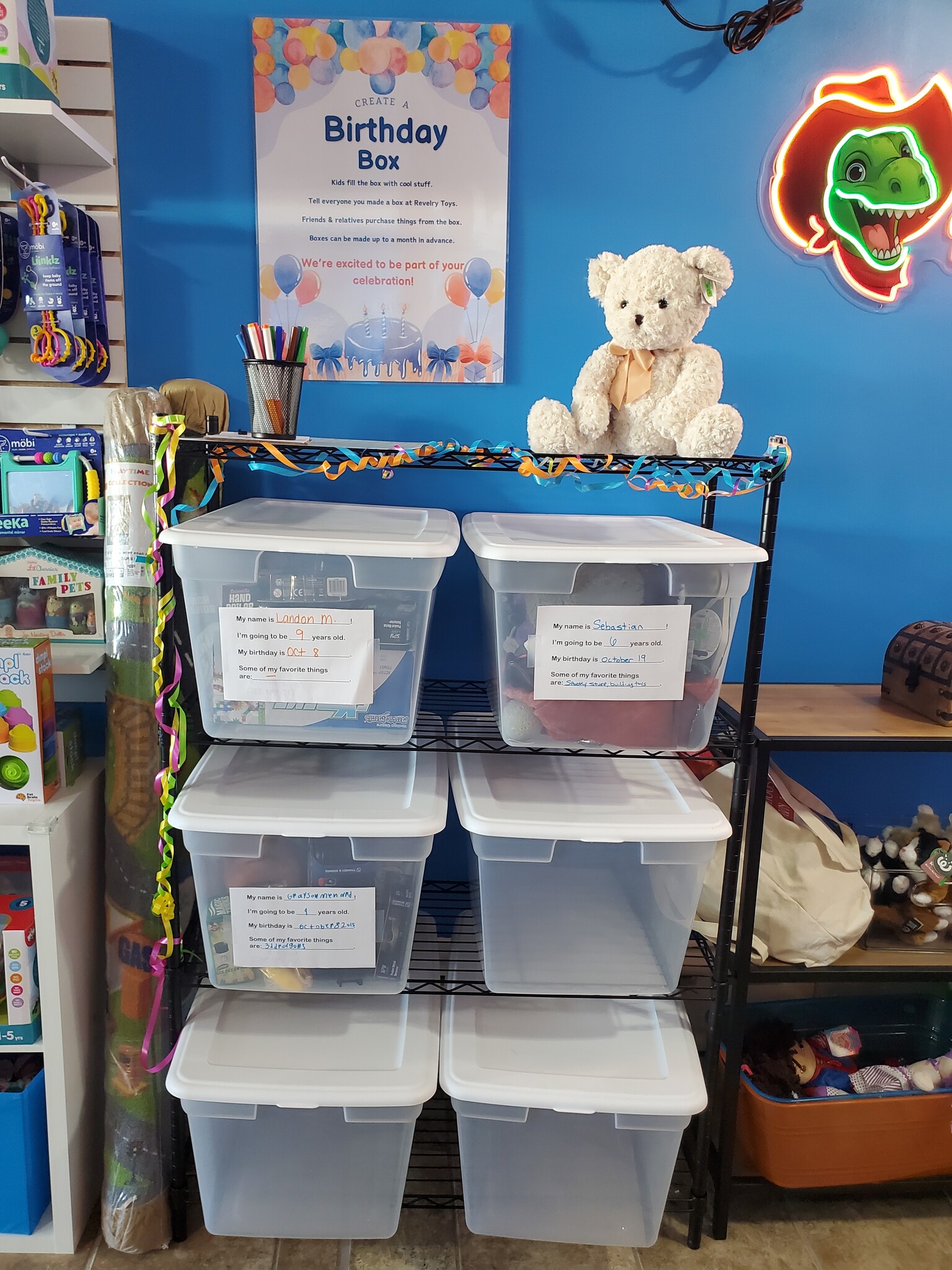 This image shows several birthday boxes filled with items ready for upcoming birthdays