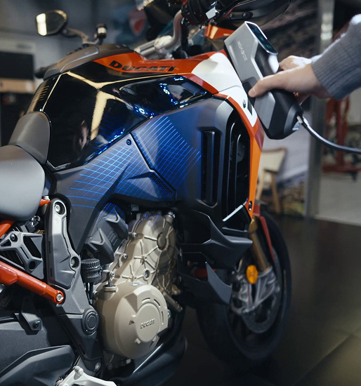 Hand holding the 3DeVOK MT and scanningn part of a motorcycle using the 34 blue laser line mode