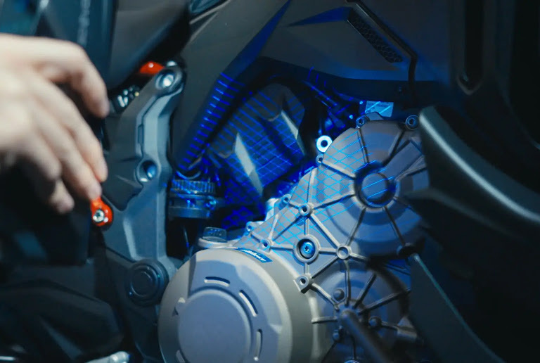 Hand holding the 3DeVOK MT and scanningn part of a motorcycle using the 34 blue laser line mode