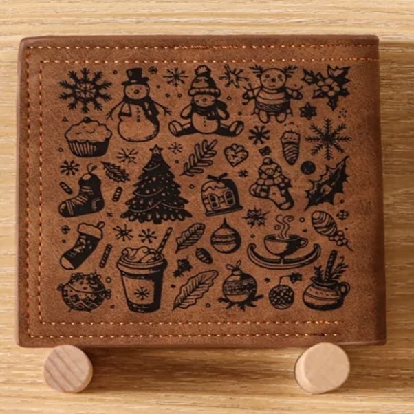 Leather wallet with laser engraved illustrations of Christmas themed items: snowman, pine tree, stockings, ...