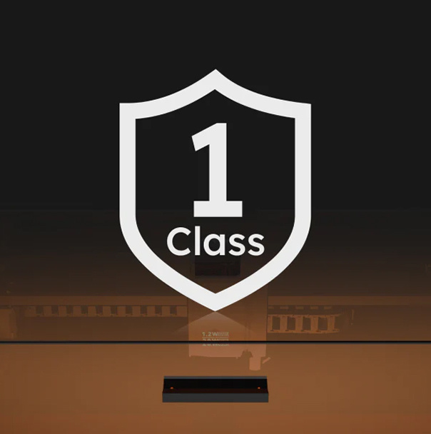 Frontal close-up of the AtomStack Kraft against a black background. On top is an illustration of a shield containing 'Class 1'