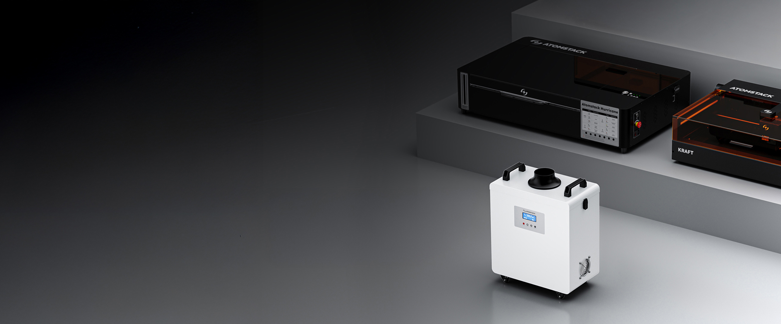 AtomStack D4 positioned in front of some steps. On the steps are the AtomStack Hurricane and AtomStack Kraft.