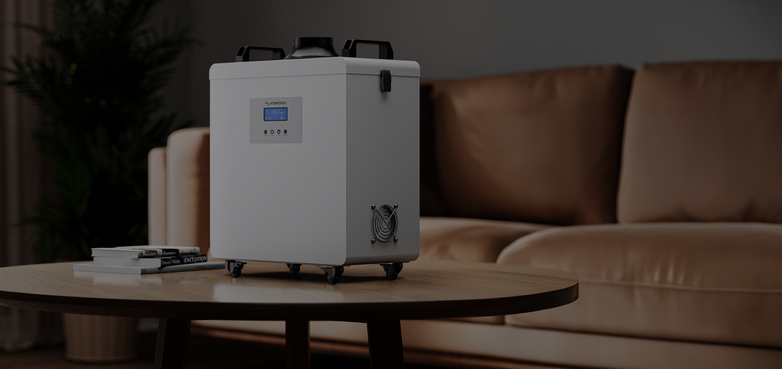 AtomStack D4 air purifier placed on a small table next to a small stack of books. In the background there is a couch.