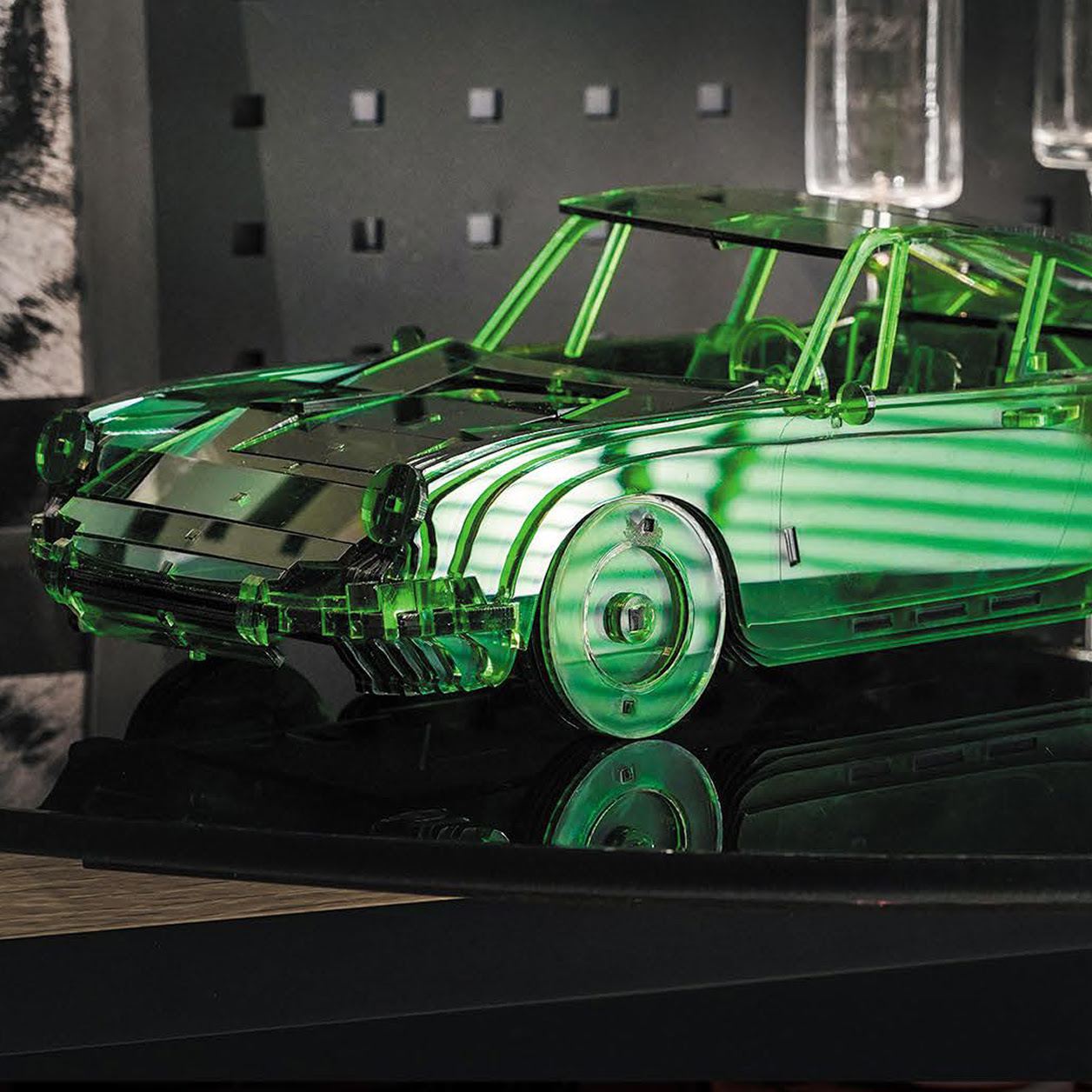 Scale 3D-model of a car in green transparent acrylic.
