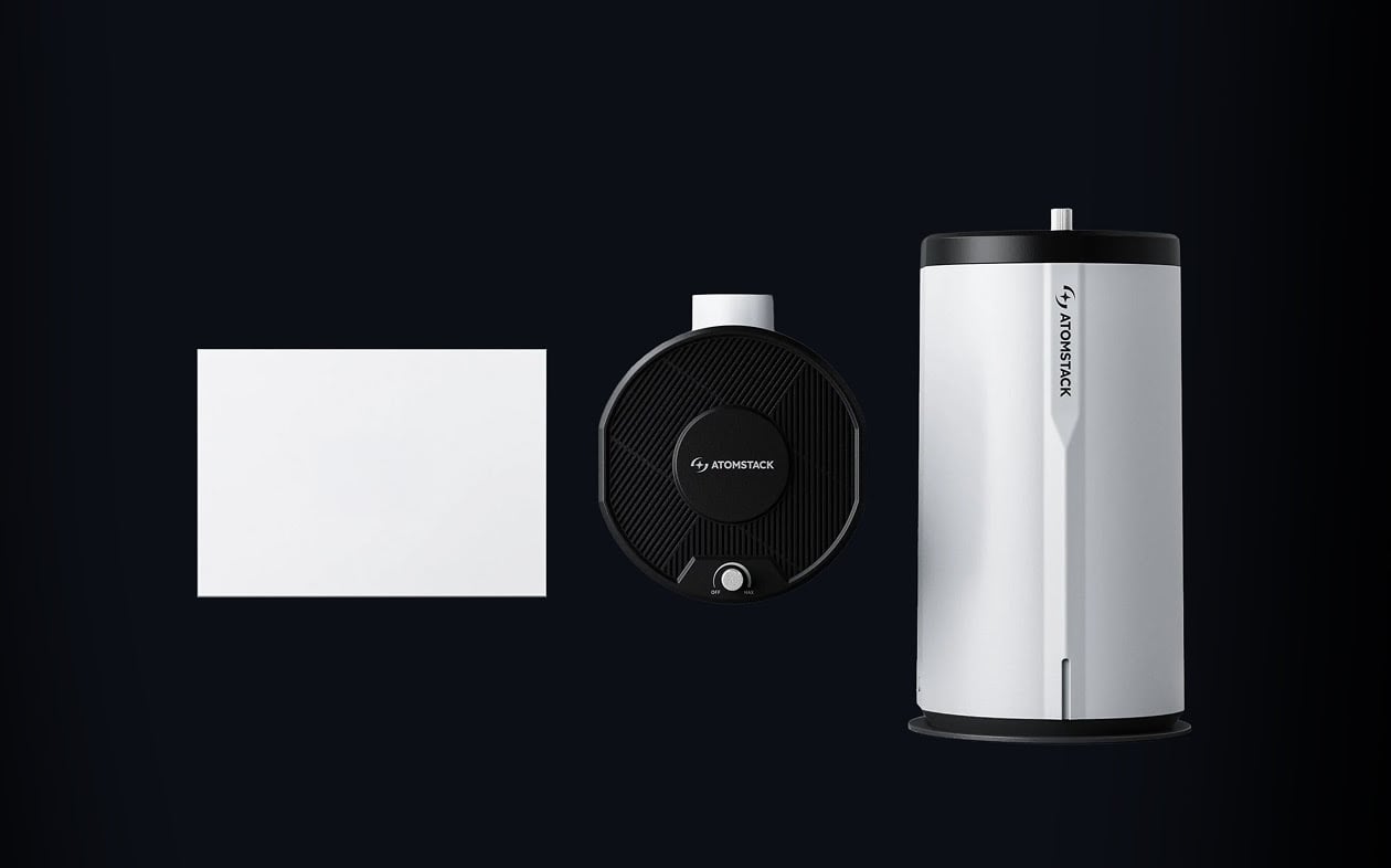 AtomStack D3 air purifier next to a top view of the D3 and a sheet of letter sized paper.