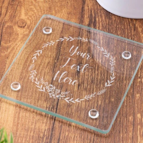 Glass coaster with a design of a wreath and the text "Your text here"