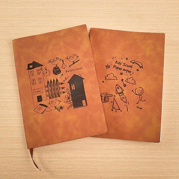 Two leather book covers with an engraved design of a childrens drawing.