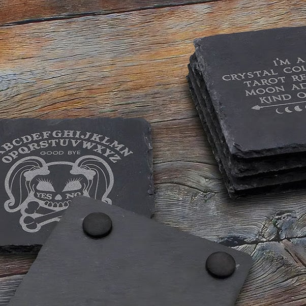 Slate coasters with engraved designs.