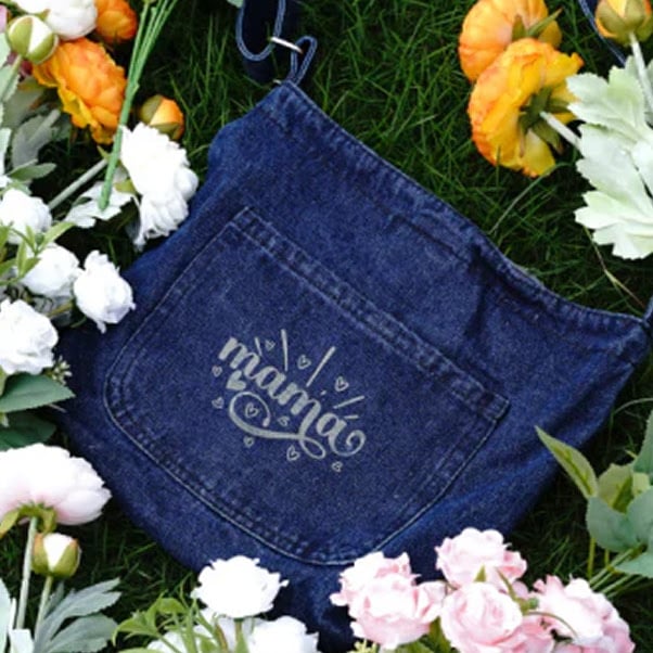 Jeans fabric with the engraved text mama on the back pocket.