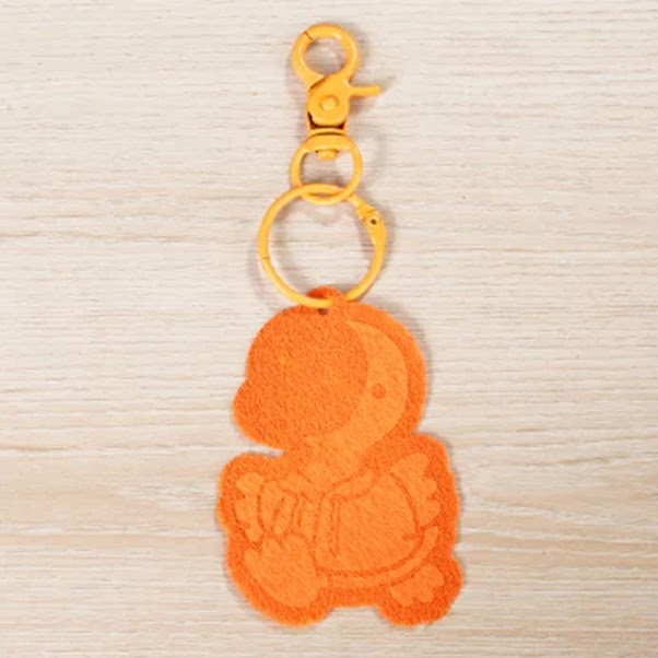 Lasercut and engraved keychain of a felt parrot illustration
