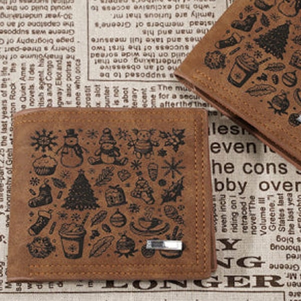 Leather wallets with a christmas pattern engraved.