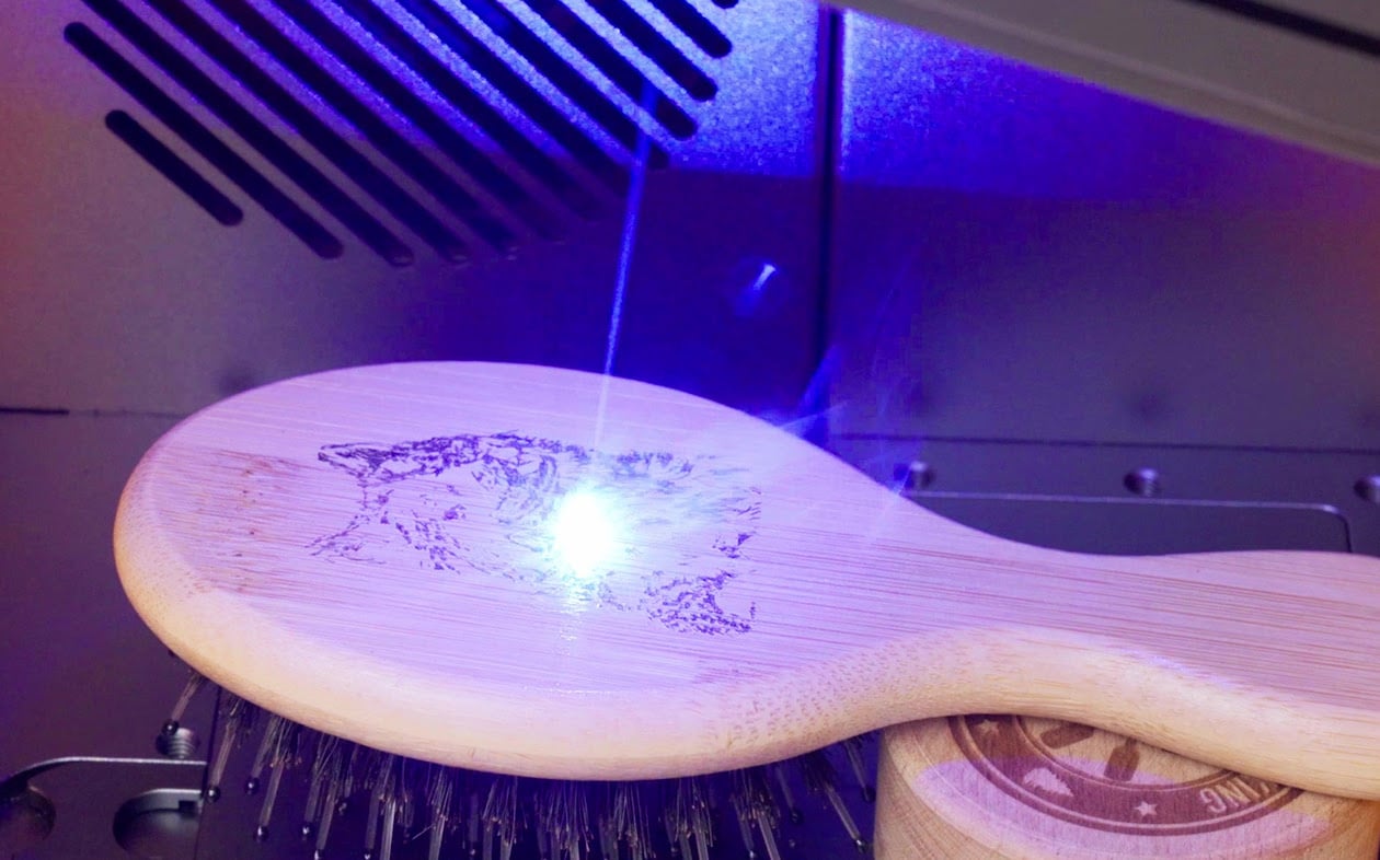 The diode laser engraving the back of a hair brush