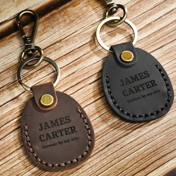 Two leather keychains engraved with the name James Carter