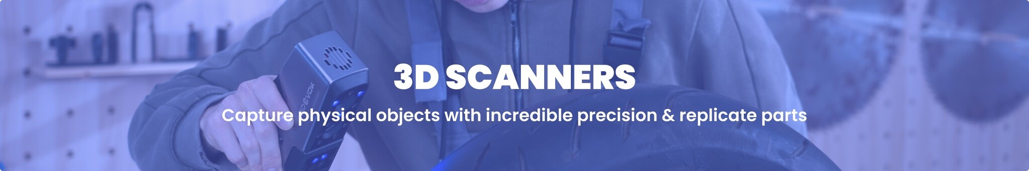 A blue-tinted banner image showing a person holding a 3D scanner pointed at a tire in a workshop setting. Overlay text on the image reads, '3D SCANNERS Capture physical objects with incredible precision & replicate parts'.