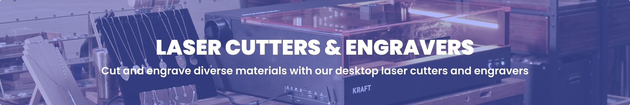 Blue titned banner of a laser cutter with diverse materials, such as metal jewelry and a wood block. Overlaid text reads: "LASER CUTTERS & ENGRAVERS. Cut and engrave diverse materials with our desktop laser cutters and engravers."