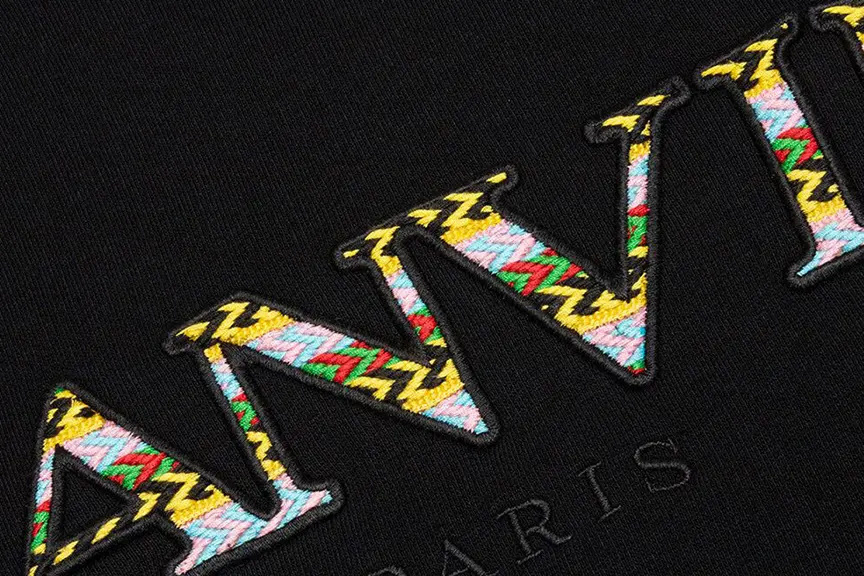 Close-up of intricate colorful pattern embroidery on black fabric executed with high precision on a BAi commercial machine